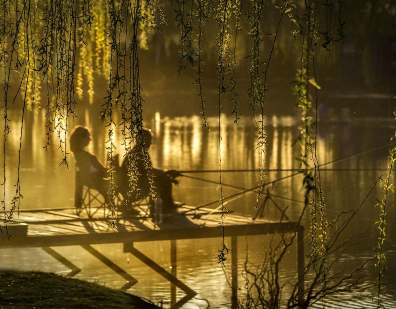 Two fishing guides checking a paper map before a river trip